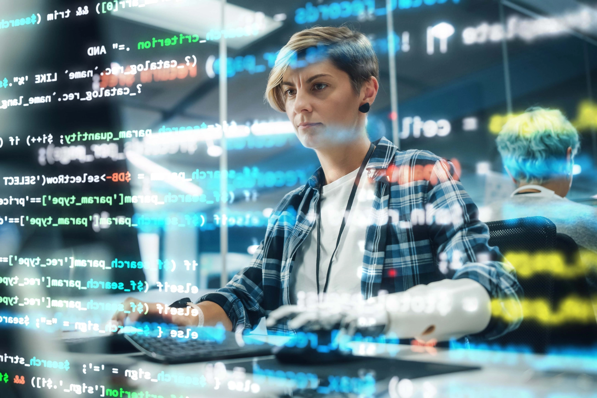 Shot with Visualisation of Running Computer Code on Foreground. Portrait of Motivated Woman with Disability Using Prosthetic Arm to Work on Computer in Body Positive Office. Myoelectric Bionic Hand